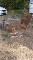 Overhead shot of entire lot on grass showing glass jugs, metal racks, deer silhouette and signs