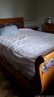 Full view of assembled bed with mattress and bedding