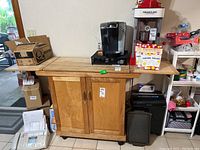 Front view of wood buffet cart with two pull-down leaves, rolling base and items on top (not included).