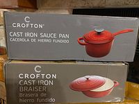 Boxes of Crofton Cast Iron Sauce Pan and Braiser showing product names and images.