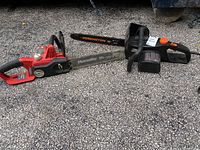 Side view of two chainsaws laid on the ground including a red Homelite with a 14-inch bar and a black Remington with a 16-inch bar.