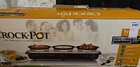 Box of Crock-Pot Trio with branding and family image on packaging indicating a slow cooker with three cooking areas.