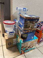 Overall image of stacked plastic and boxed glass storage containers in various sizes