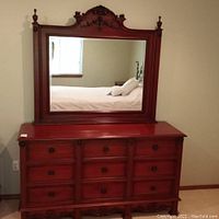Full frontal view of the mahogany dresser with attached mirror showing the structure, drawer layout, and mirror details.