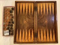 Closed game case showing beveled wooden construction and dovetail joints with rich varnish finish.