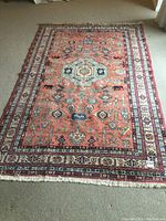 Full view of carpet laid flat showing overall pattern and fringes