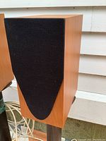 Front view of left speaker with grille on stand