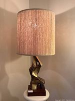 Full view of lamp on tabletop showing overall height, form, and shade