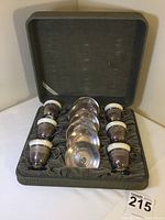 Six cup holders with porcelain inserts and saucers arranged in original fitted box