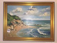 Full view of framed oil painting showing seascape scene and signature