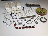 Overview of varied jewelry pieces laid out on table