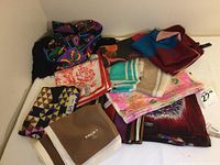 Full view of the 11-piece lot of various vintage scarves including Bob Mackie shawl and multiple brands.
