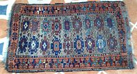 Full view of woven rug lying flat, showing entire pattern and colors.
