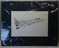 Full view of the matted black and white print of U.S. Navy F-14 Tomcat wrapped in plastic.