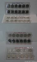 Four sets of Canadian quarters displayed in protective sleeves, showing two full 2000 Millennium quarter sets and two 1999 quarter sets (one complete and one partial) arranged in plastic holders.