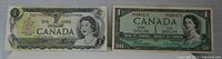 Photo showing two 1-dollar Canadian bills, one circulated and one with green background uncirculated