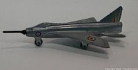 Side view of the silver die-cast model airplane showing painted roundels and black nose cone on landing gear.