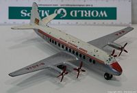 Metal diecast model of Vickers Viscount airplane in BEA livery, showing paint chips and wear with red propellers and small wheels.