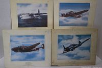 Four WWII aircraft illustrations showing Catalina on water, Wellington, and two other aircraft in flight with visible rough, marked mattes and some creasing.
