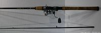 Two-piece Crossfire 702MFS fishing rod with cork handle, laid flat showing full length and condition.