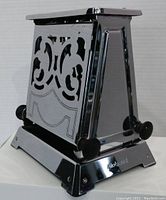 Side view showing decorative cut-out panels and chrome finish of the vintage Hotpoint toaster.