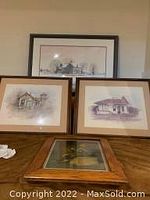Three framed prints: one large panoramic train station print at top, two smaller train station prints below with wooden frames.