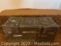 Top and front view of green metal military box with latches showing wear and original markings.
