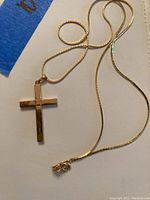 Overall view of 10K gold cross pendant on 18-inch box chain