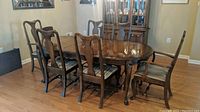 Full view of the dining table with six chairs around it in a dining room setting.