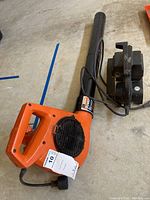 Orange Sears Craftsman power leaf blower with black blower tube and vent, showing model label and power cord.