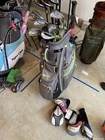 Full view of Nike golf bag with clubs and scattered headcovers