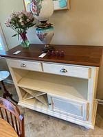 Front view of the wooden server showing two drawers, wine rack, and cabinet.