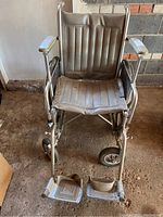 Front view of Everest Jennings wheelchair showing vinyl seat, armrests, and footrests.