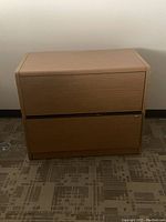 Front view of a 2-drawer wood veneer file credenza with lock on the lower drawer.