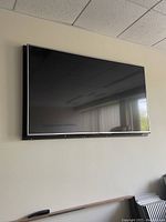 LG flat screen television mounted on wall