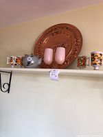 View showing all items including copper tray, owl teapot, pink glasses, and floral cups on shelf