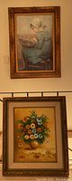 Two framed artworks displayed, one floral acrylic painting signed Murray and one portrait of a child.