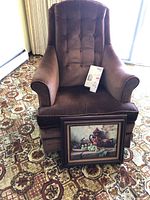 Vintage brownish swivel rocking chair with button tufted high back and padded arms, shown in front and angled views.
