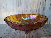 Front view of the oval carnival glass fruit bowl showing scalloped edge and iridescent gold finish.