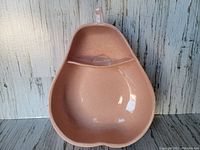 Pear shaped chip and dip dish viewed from above showing the dipped division and handle