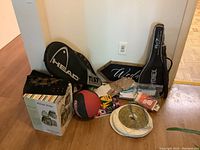Lot contents including tennis racquets, basketball, paper lanterns, wedding sign, stationery and boxed picnic wine holder