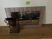 Mirror with decorative metal cutout frame and a reflection of the room
