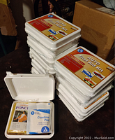 Stack of 10 sealed white plastic Auto First Aid Kits labeled 'MTS-71A'