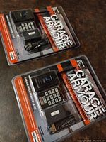 Two Garage Armour security remote and keypad kits in original packaging.