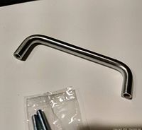 Nickel finished Amerock bar drawer/cabinet pull with bag of screws shown on white background, photo taken to show item condition and included hardware.