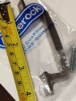 Amerock branded pull out of the package with measuring tape showing about 3 inch center to center spacing