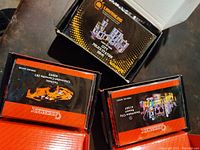 Three Briksmax LED lighting kit boxes for Lego projects, showing Ferrari 488 GTB, Concert City, and City Police Station sets