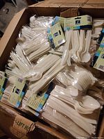 Photo showing multiple packs of the 24-piece disposable utensil sets inside a box.