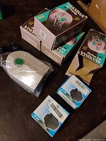 Photo showing 4 Maxima air pumps in boxes and 2 smaller boxed mini water pumps on table.