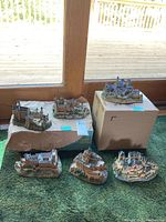 All six castle replicas displayed together on floor and boxes, arranged for clear view of each model.
